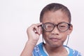 closeup, asian teenager holding nearsighted glasses. vision examination concept, eye fatigue, diagnosis