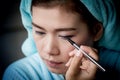 Closeup asian woman applying eyeliner on eye Royalty Free Stock Photo