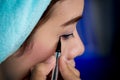 Closeup asian woman applying eyeliner on eye Royalty Free Stock Photo