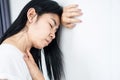 Asian woman fainting lean her head on the wall feeling dizzy
