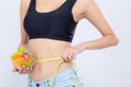 Closeup asian woman holding salad vegetable food and measuring waist for weight isolated on white background Royalty Free Stock Photo