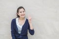 Closeup asian woman holds up three finger motion with smile face on marble stone wall textured background with copy space