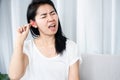 Asian woman hurts from cleaning ear wax by cotton bud that put too deep inside her ear