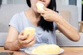 Asian woman over eating Durian fruit, unhealthy lifestyle