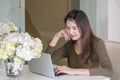 Closeup asian woman use computer notebook in room with happy face emotion under window light in lifestyle of woman concept Royalty Free Stock Photo