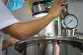 Closeup Asian worker working with ferment machine Royalty Free Stock Photo