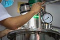 Closeup Asian worker working with ferment machine Royalty Free Stock Photo