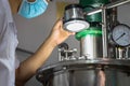Closeup Asian worker working with ferment machine Royalty Free Stock Photo
