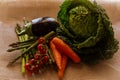 Closeup of asparagus, cabbage, carrots, eggplant, and tomatoes on a brown table cloth Royalty Free Stock Photo