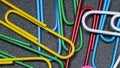 Closeup of assorted colorful paperclips isolated on black background Royalty Free Stock Photo