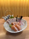 Closeup assorted Sashimi, salmon and Swordfish belly with teapot in background. Top view