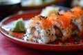 closeup assorted set of delicious appetizing sushi and roll on red plate
