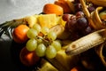 closeup assortment of sliced tropical fruits on big plate