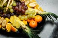 closeup assortment of sliced tropical fruits on big plate