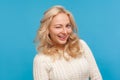 Closeup attractive blond woman in knitted sweater winking looking at camera with toothy smile, flirting, femininity