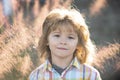 Closeup attractive boy outdoor. Portrait of young smiling child. Kids emotions concept. Blur background. Royalty Free Stock Photo