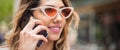 Closeup of attractive fashion woman talking on mobile cellphone phone Royalty Free Stock Photo