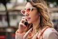 Closeup of attractive fashion woman talking on mobile cellphone phone Royalty Free Stock Photo