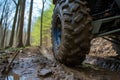 closeup of an atvs muddy wheel in the forest Royalty Free Stock Photo