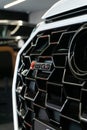 Closeup of the Audi RSQ3 model name on the front grill, vertical shot