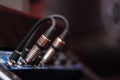 Closeup audio cables plugged into studio hardware, artistic equipment concept