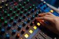 Closeup audio engineer hand on sound mixer control panel