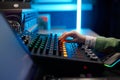 Closeup audio engineer hand on sound mixer control panel