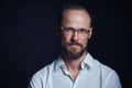 Concentraited middle age man in white shirt and eyeglasses looking squinting at camera Royalty Free Stock Photo