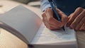 Closeup author hands writing notebook in office. Creative man noticing on paper Royalty Free Stock Photo