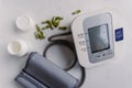 Closeup of an automatic blood pressure meter and pills. Royalty Free Stock Photo