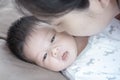 Closeup a baby on bed with her mother give a kiss Royalty Free Stock Photo