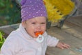 Closeup of a baby crying with a pacifier in his mouth. Royalty Free Stock Photo