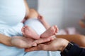 Closeup of baby feet and hands of parents Royalty Free Stock Photo