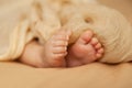 Closeup of baby feet, newborn toes on a beige background, maternity and babyhood concept Royalty Free Stock Photo