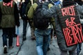 Closeup of the Back of a protester Wearing a Sign