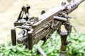 Closeup and back view of M2 .50cal Browning machine gun with tripod standing in bunker Royalty Free Stock Photo