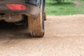 Closeup backside of dirty wheel from soil after rain in back side at the car park background Royalty Free Stock Photo