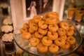 Closeup of baked mini donuts on a tray on the table during an event Royalty Free Stock Photo