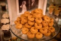 Closeup of baked mini donuts on a tray on the table during an event