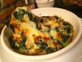 Closeup baked spinach with cheese