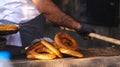 Closeup of a baker baking delicious simit in traditional oven Royalty Free Stock Photo