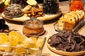 Closeup bakery and snacks, dried fruits, pieces parmesan cheese, honeycombs, dark chocolate, cinnamon sticks, raisin biscotti. Royalty Free Stock Photo