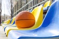 Closeup of ball on the school stadium seats.Concept of basketball competition at the local sport court Royalty Free Stock Photo