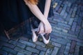 Closeup of ballerina`s feet in pointe on street. Strong fit ballerina`s legs