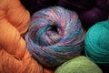 Closeup of balls and skeins of yarns, richly colored, knitting and crochet handicraft background