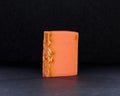 Closeup of a bar of orange-scented soap against a black background Royalty Free Stock Photo