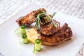 Closeup of barbecued pork ribs on white plate