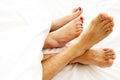 Closeup of bare feet of love couple, making out