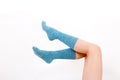 Closeup of the bare legs of a young woman wearing blue socks with his feet. Isolated on white background. Studio lighting Royalty Free Stock Photo