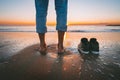 Closeup of barefoot man walking on the summer beach at sunset. Without shoes Royalty Free Stock Photo